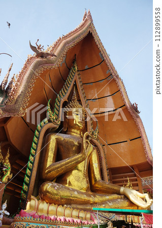 Golden huge Buddha statue is located on the top of the mountain in Thailand Golden huge Buddha statue is located on the top of the mountain in Thailand 112899558