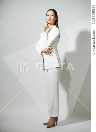 Career woman wearing a white suit Career woman wearing a white suit 112899582