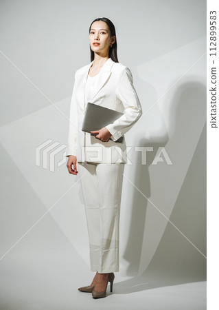 Career woman wearing a white suit 112899583