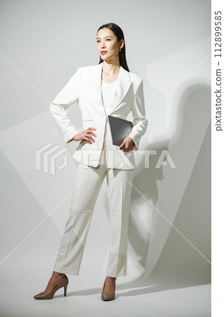 Career woman wearing a white suit 112899585