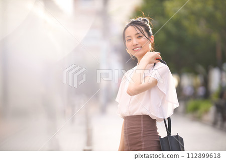 Young woman enjoying shopping in the city at sunset Young woman enjoying shopping in the city at sunset 112899618