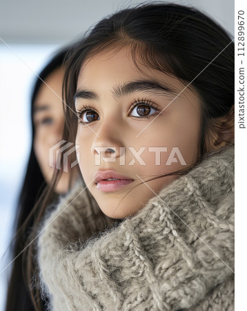 AI-generated content. young girl wrapped in a cozy pullover, with her mothers presence softly in the background - peaceful familial bond. 112899670