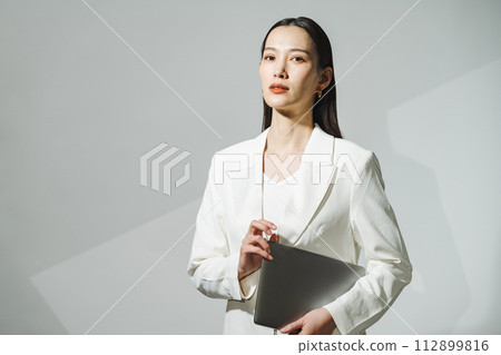 Career woman wearing a white suit 112899816
