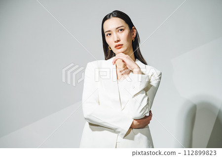Career woman wearing a white suit Career woman wearing a white suit 112899823
