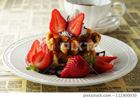 Belgian waffles and strawberries with chocolate sauce and coffee 112900030