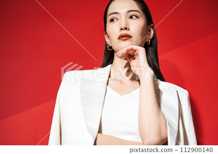 Career woman wearing a white suit Career woman wearing a white suit 112900140