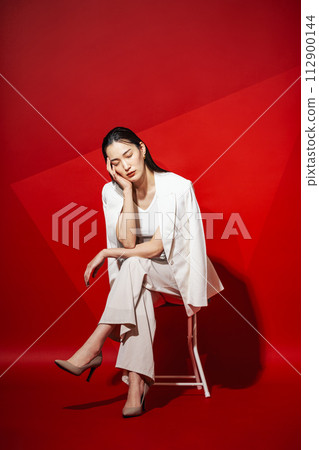 Career woman wearing a white suit Career woman wearing a white suit 112900144