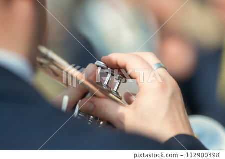 Details of hands playing the trumpet Details of hands playing the trumpet 112900398