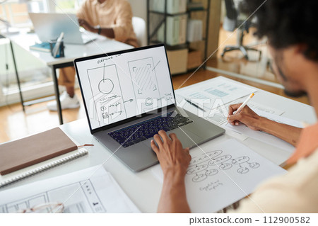 UI designer working on mobile app wireframe 112900582