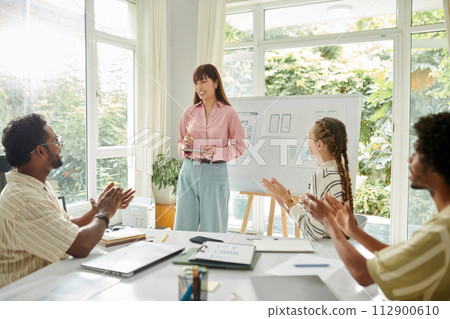 Team members applauding to UI designer after her project presentation 112900610