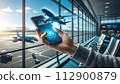 A hand holds a phone displaying a 3D airplane hologram, 112900879