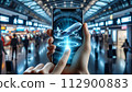 A hand holds a phone displaying a 3D airplane hologram, 112900883