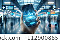 A hand holds a phone displaying a 3D airplane hologram, 112900885