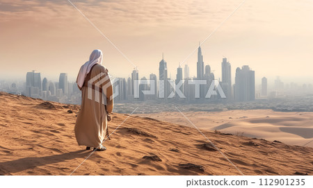 AI-generated content. Arab man walking at desert and watching futuristic city with skyscrapers on horizon at sunset AI-generated content. Arab man walking at desert and watching futuristic city with skyscrapers on horizon at sunset 112901235