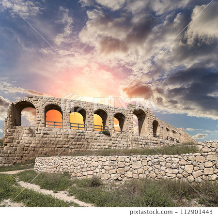 Roman ruins (against the background of a beautiful sky with clouds) in the Jordanian city of Jerash (Gerasa of Antiquity), capital and largest city of Jerash Governorate, Jordan Roman ruins (against the background of a beautiful sky with clouds) in the Jordanian city of Jerash (Gerasa of Antiquity), capital and largest city of Jerash Governorate, Jordan 112901443