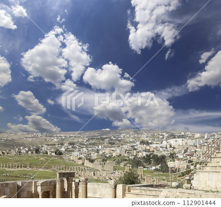 Roman ruins (against the background of a beautiful sky with clouds) in the Jordanian city of Jerash (Gerasa of Antiquity), capital and largest city of Jerash Governorate, Jordan Roman ruins (against the background of a beautiful sky with clouds) in the Jordanian city of Jerash (Gerasa of Antiquity), capital and largest city of Jerash Governorate, Jordan 112901444