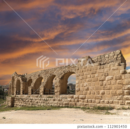 Roman ruins (against the background of a beautiful sky with clouds) in the Jordanian city of Jerash (Gerasa of Antiquity), capital and largest city of Jerash Governorate, Jordan Roman ruins (against the background of a beautiful sky with clouds) in the Jordanian city of Jerash (Gerasa of Antiquity), capital and largest city of Jerash Governorate, Jordan 112901450