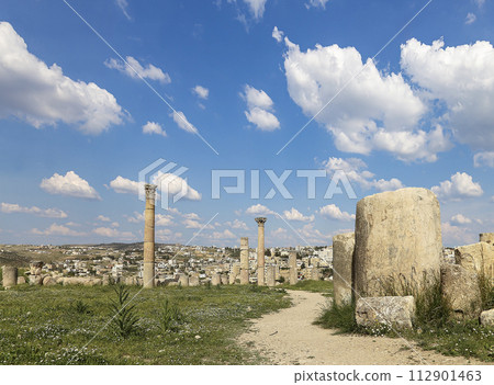 Roman ruins (against the background of a beautiful sky with clouds) in the Jordanian city of Jerash (Gerasa of Antiquity), capital and largest city of Jerash Governorate, Jordan Roman ruins (against the background of a beautiful sky with clouds) in the Jordanian city of Jerash (Gerasa of Antiquity), capital and largest city of Jerash Governorate, Jordan 112901463