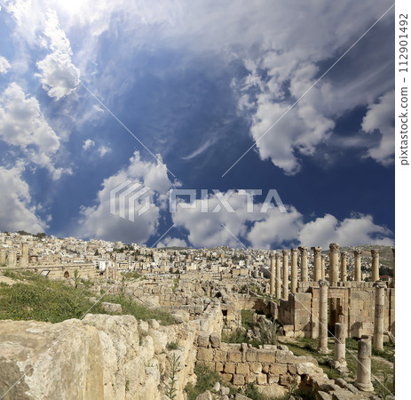 Roman ruins (against the background of a beautiful sky with clouds) in the Jordanian city of Jerash (Gerasa of Antiquity), capital and largest city of Jerash Governorate, Jordan 112901492