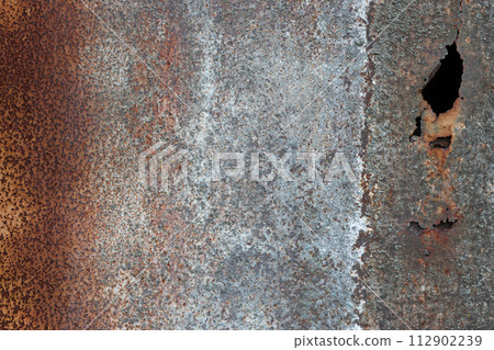 Dark worn rusty metal texture background. Very old dark orange metal sheet with damaged parts as texture for walls or surfaces 112902239