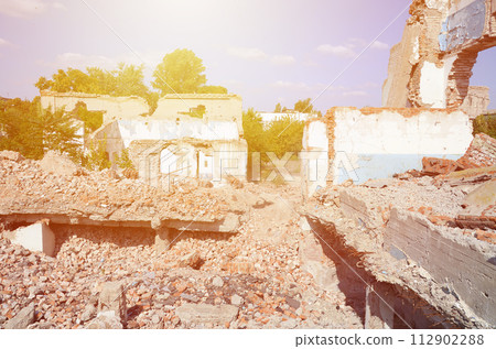 Collapsed industrial multistorey building in daytime. Disaster scene full of debris, broken bricks and damaged non residental house. Concept of war action aftermath or building demolition Collapsed industrial multistorey building in daytime. Disaster scene full of debris, broken bricks and damaged non residental house. Concept of war action aftermath or building demolition 112902288