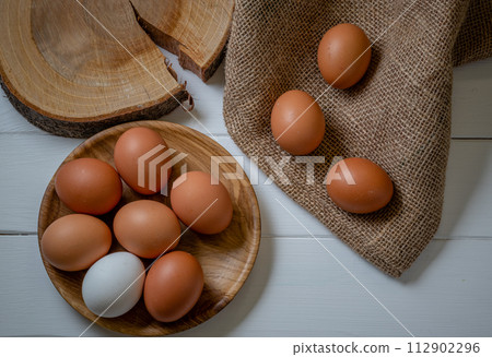 Fresh chicken eggs on the table, selective focus 112902296