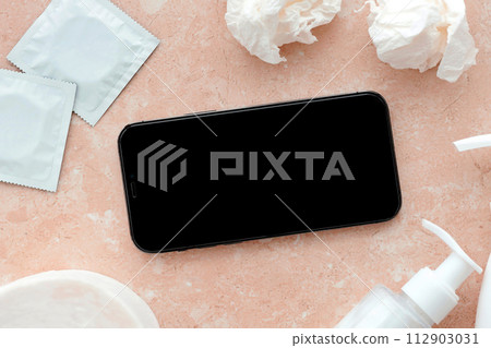 Mockup for adult content website or app on smartphone display with porn watching attributes for masturbation. Copy space 112903031