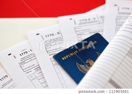 Indonesian tax forms 1770 Individual Income Tax Return and passport on table close up 112903081