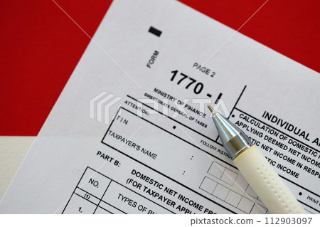 Indonesian tax form 1770-1 Individual Income Tax Return and pen on table close up Indonesian tax form 1770-1 Individual Income Tax Return and pen on table close up 112903097