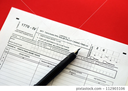 Indonesian tax form 1770-4 Individual Income Tax Return and pen on table close up 112903106
