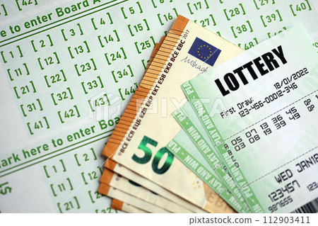Green lottery tickets and euro money bills on blank with numbers for playing lottery close up Green lottery tickets and euro money bills on blank with numbers for playing lottery close up 112903411
