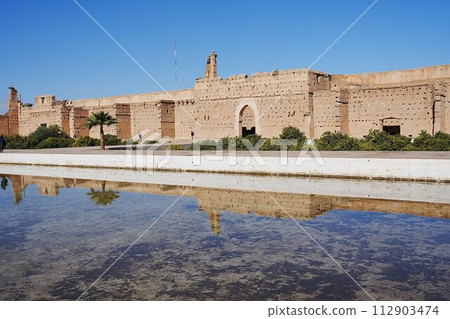 El Badi palace reflected in water in Marrakech city in Morocco 112903474