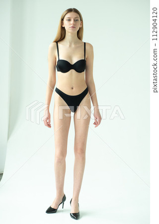 Studio model test, snap, polaroid. Beautiful young european woman on white background 112904120
