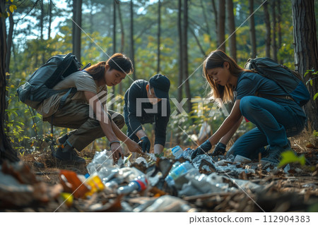 Volunteers Collecting Trash in Forest During Daylight 112904383