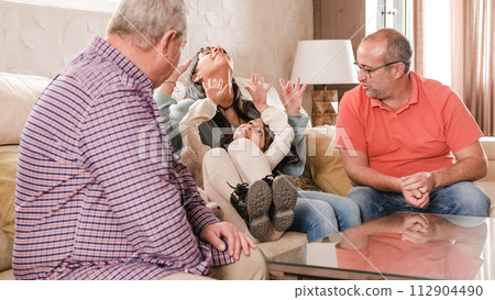 Playful non- normative family sitting on the sofa 112904490