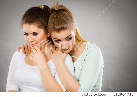 Woman hugging her sad female friend Woman hugging her sad female friend 112904715