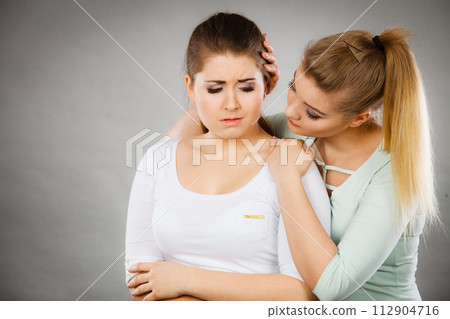 Woman hugging her sad female friend Woman hugging her sad female friend 112904716