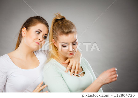 Woman hugging her sad female friend Woman hugging her sad female friend 112904720