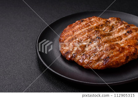 Delicious fresh grilled chicken fillet with spices and herbs Delicious fresh grilled chicken fillet with spices and herbs 112905315
