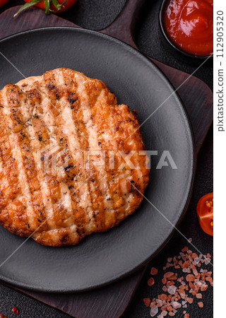 Delicious fresh grilled chicken fillet with spices and herbs Delicious fresh grilled chicken fillet with spices and herbs 112905320