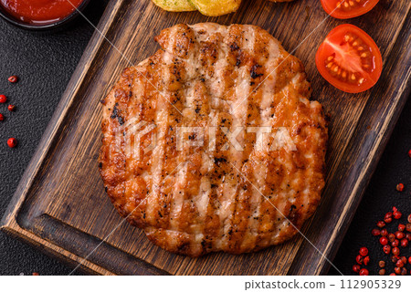 Delicious fresh grilled chicken fillet with spices and herbs Delicious fresh grilled chicken fillet with spices and herbs 112905329