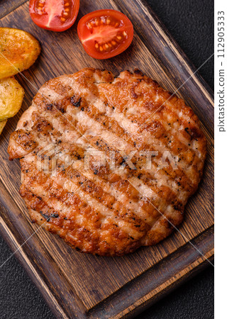 Delicious fresh grilled chicken fillet with spices and herbs 112905333