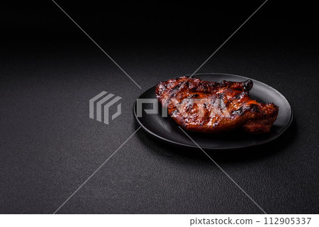 Fresh juicy delicious beef steak on a dark background 112905337