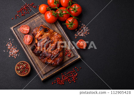 Fresh juicy delicious beef steak on a dark background 112905428