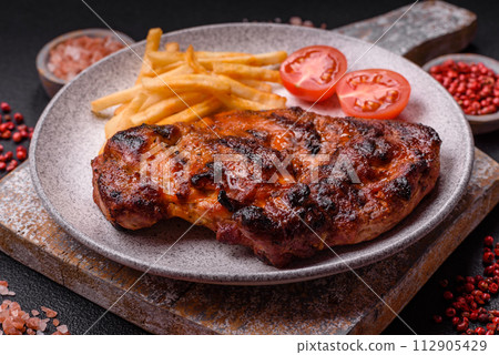 Fresh juicy delicious beef steak on a dark background 112905429