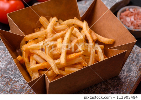 Delicious crispy golden fries with salt and spices 112905484