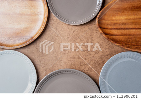 Pottery and wooden plates and vessels | Frame | Brown background 112906201
