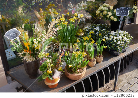 Beautiful spring flowers in front of flower shop on a spring day. Easter floral arrangements. Beautiful spring flowers in front of flower shop on a spring day. Easter floral arrangements. 112906232