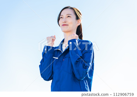 A young woman working in the logistics industry fist-pumping A young woman working in the logistics industry fist-pumping 112906759