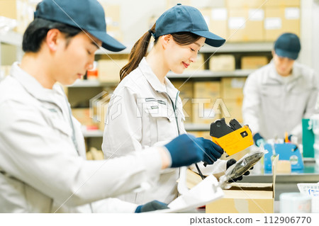 Young staff doing light work in the backyard 112906770